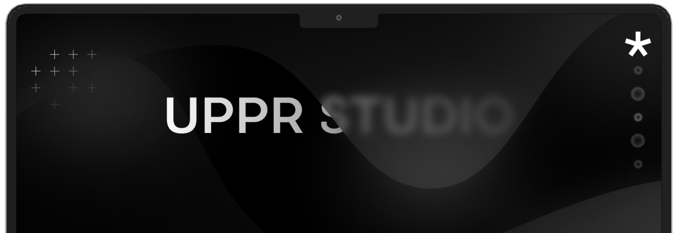 A mockup laptop containing the slogan UPPR STUDIO